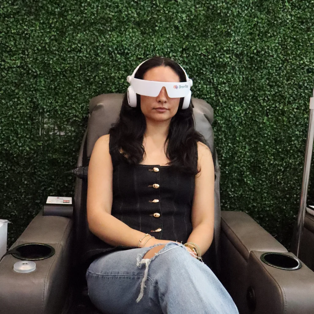 Patient relaxing during a BrainTap brainwave entrainment session at AgeRejuvenation